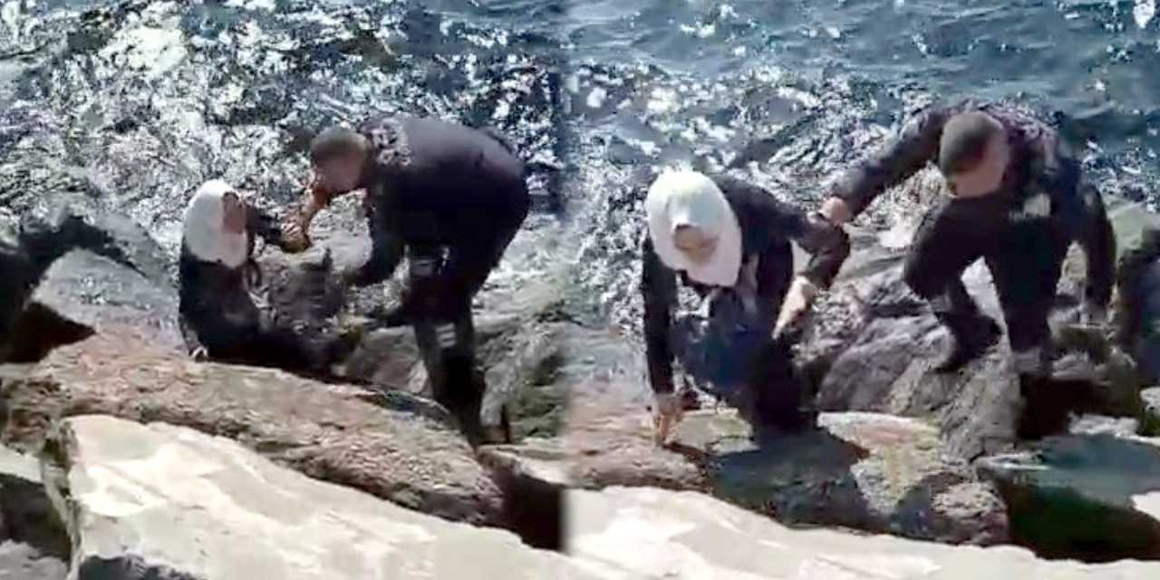 Sahilde yürürken kayalıkların arasına düştü! Yardımına güvenlik görevlisi koştu