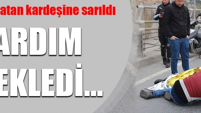 Yerde yatan kardeşine sarılarak yardım bekledi