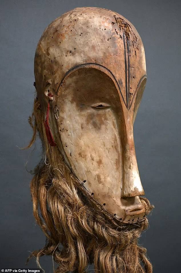 76389187-12695563-fang-masks-highly-stylised-and-carved-from-wood-are-made-by-the-a-70-1698796673798.jpg