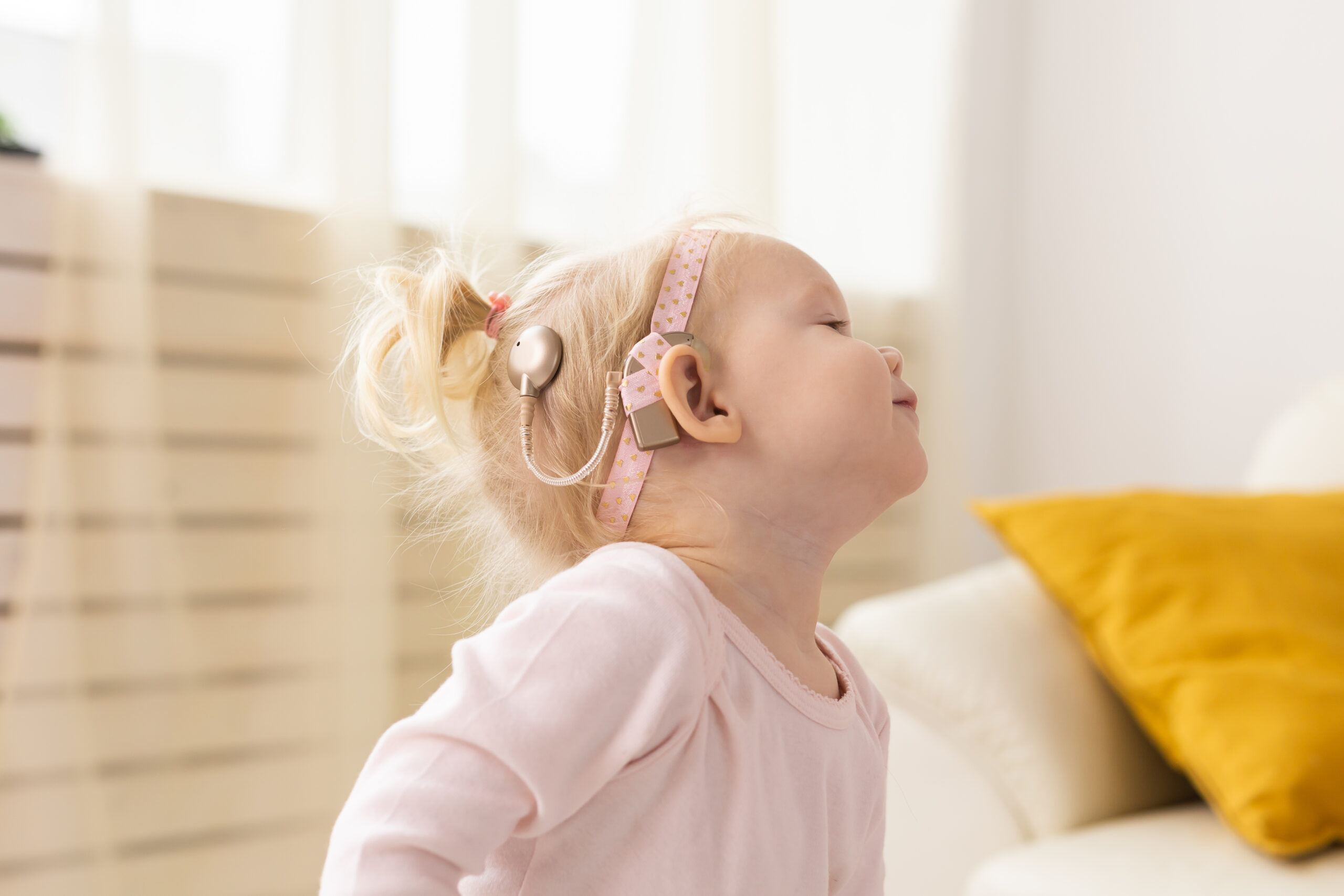 baby-with-cochlear-implants-having-fun-at-home-de-2022-03-16-07-36-21-utc-scaled.jpg