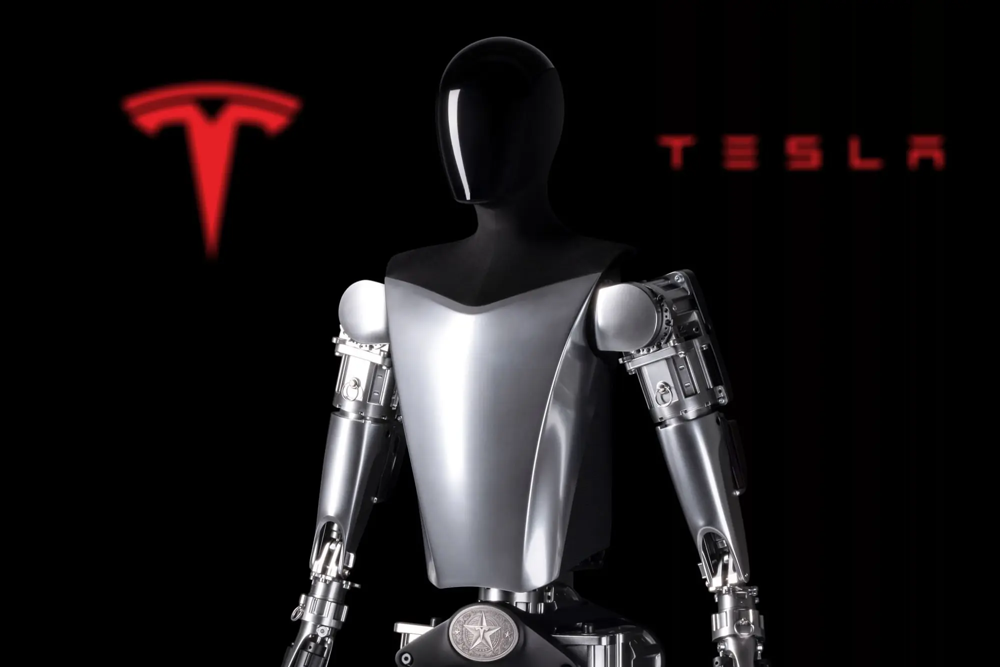teslas-2022-optimus-robot-prototype-is-seen-in-front-of-the-company-logo.webp